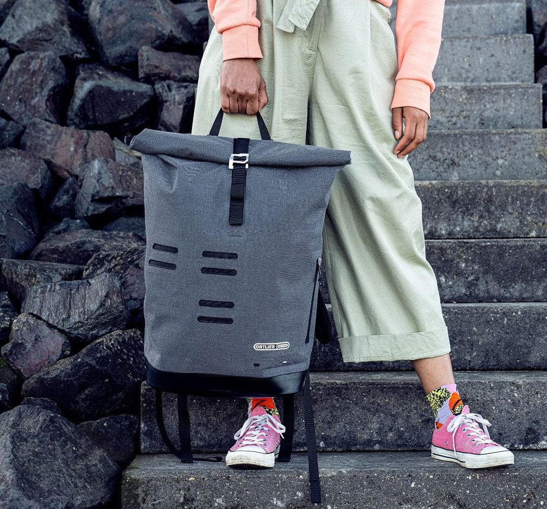 Person Holding the Ortlieb Commuter Daypack Urban Backpack Against Background of Stone Steps