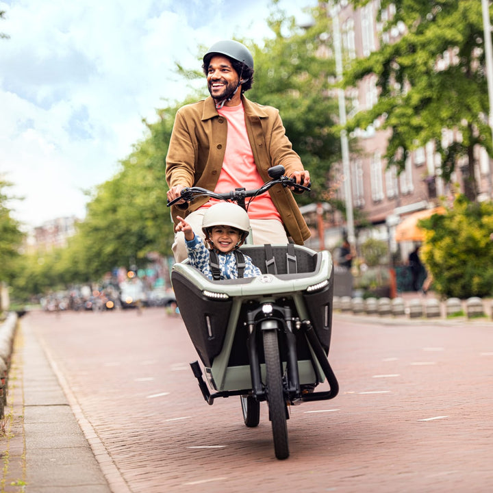 Dad driving Urban Arrow with happy child in the front seat