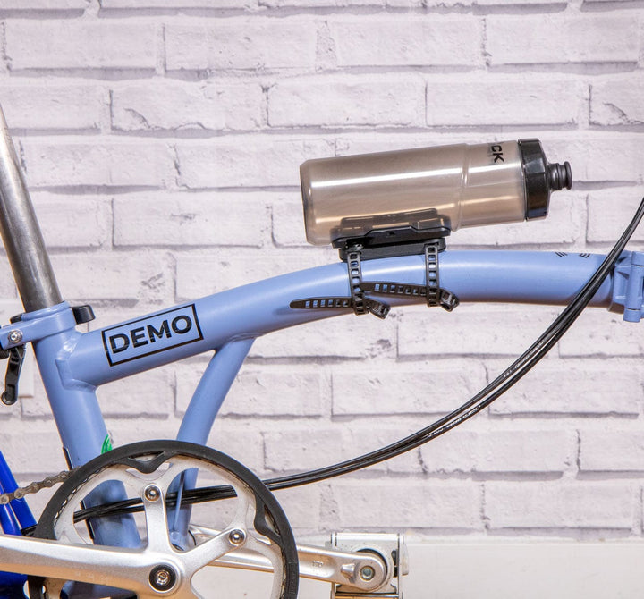Fidlock Cageless Water Bottle - 600mL with Universal Base Adapter displayed on a brompton