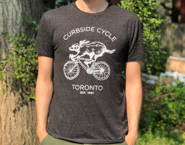 Curbside Cycle Cycling Badger T-Shirt in Colour Black on Male Model Outside in the Sun