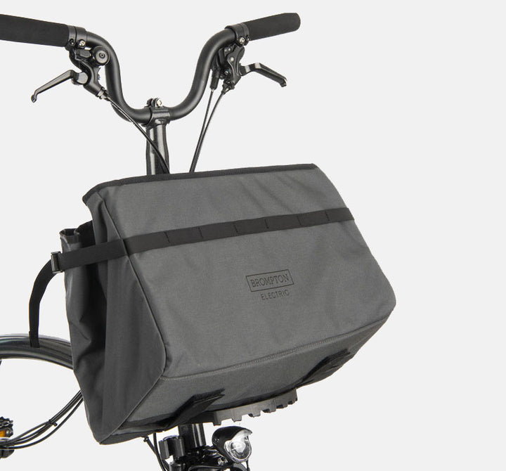 Brompton Electric Borough Basket Bag in Dark Grey Pictured on Black Electric Folding Bike