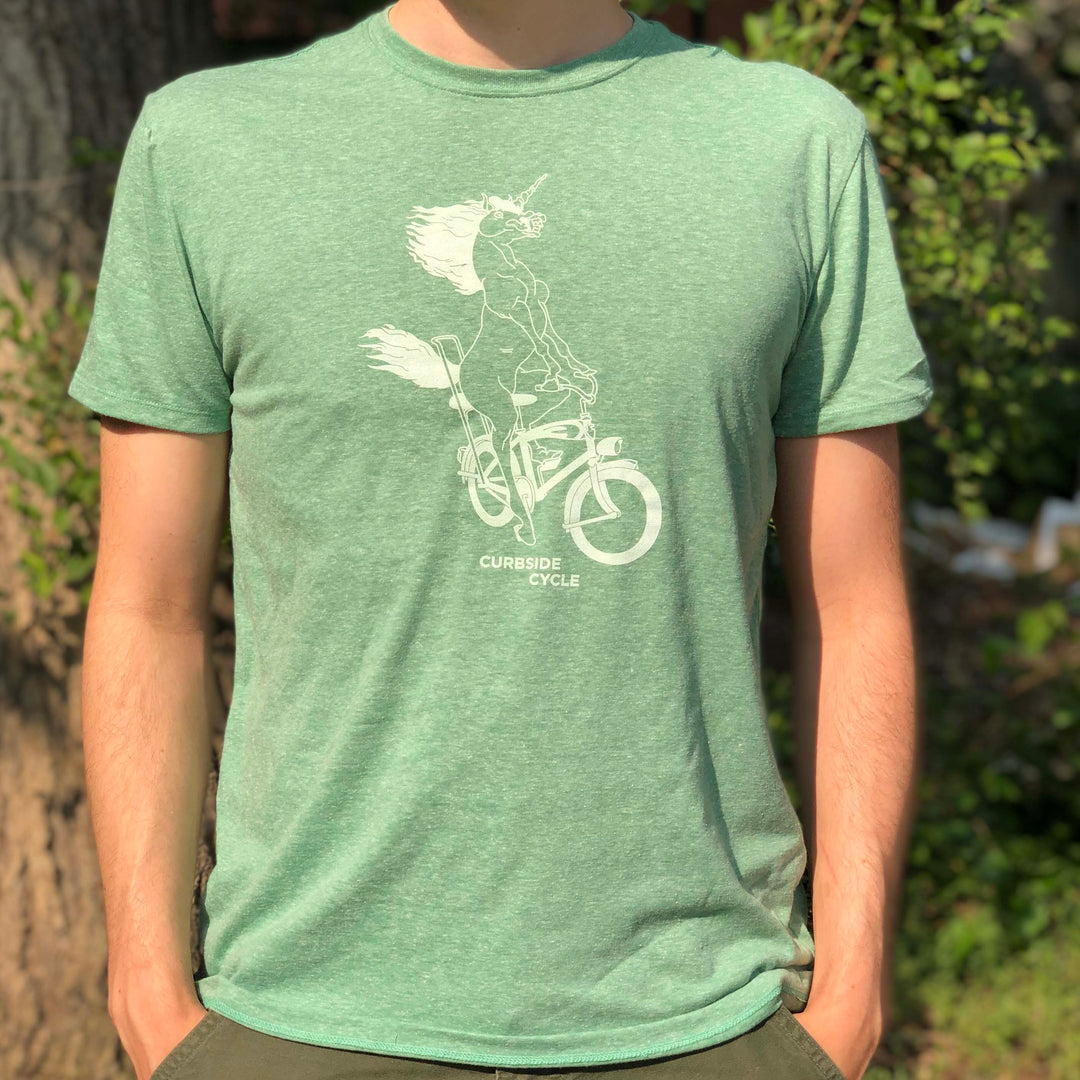 Curbside Cycle Bike Riding Unicorn T-Shirt in Colour Green on Male Model Outside in the Sun