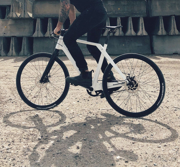 Lifestyle Photo of Man Riding White Coh & Co Erik Urban Bike with Belt Drive (6670778630195)