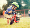 Child beside Frog Tadpole Mini Balance Bike in Red (605681811507)