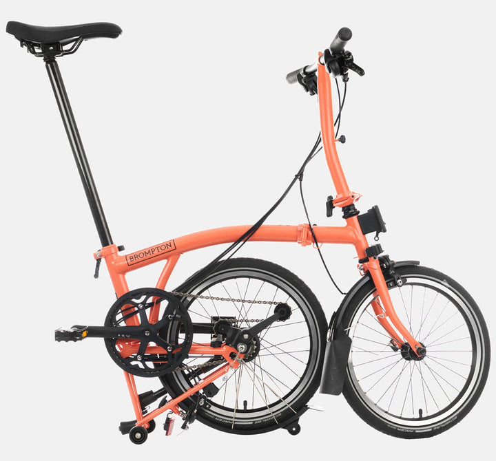 2023 Brompton C Line Explore Low Handlebar 6-speed folding bike in Fire Coral - kickstand mode