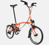 2023 Brompton C Line Explore Mid Handlebar 6-speed folding bike in Fire Coral