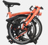 2023 Brompton C Line Explore Mid Handlebar 6-speed folding bike in Fire Coral - folded