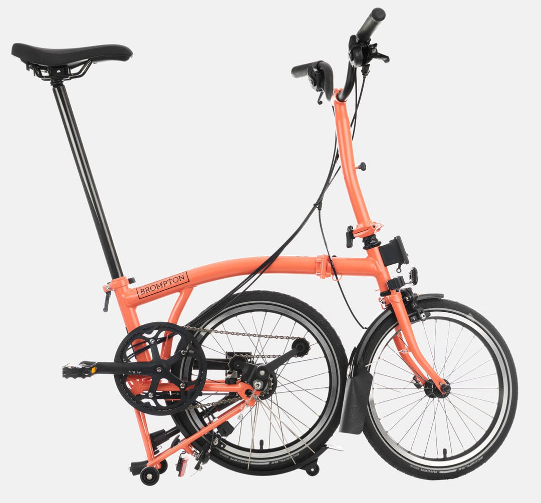 2023 Brompton C Line Explore Mid Handlebar 6 speed folding bike in Fire Coral - kickstand mode