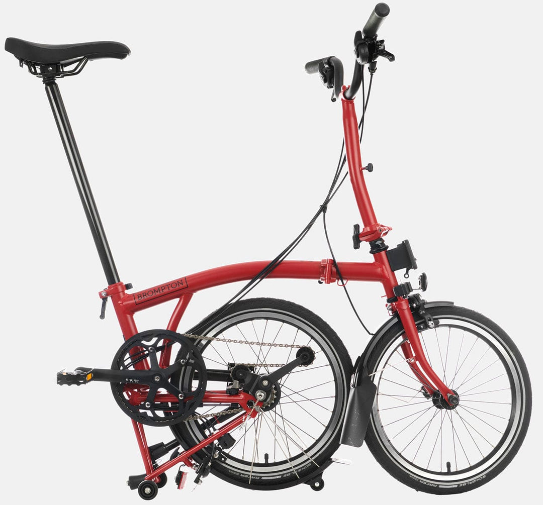 2023 Brompton C Line Explore Mid Handlebar 6-speed folding bike in House Red - kickstand mode