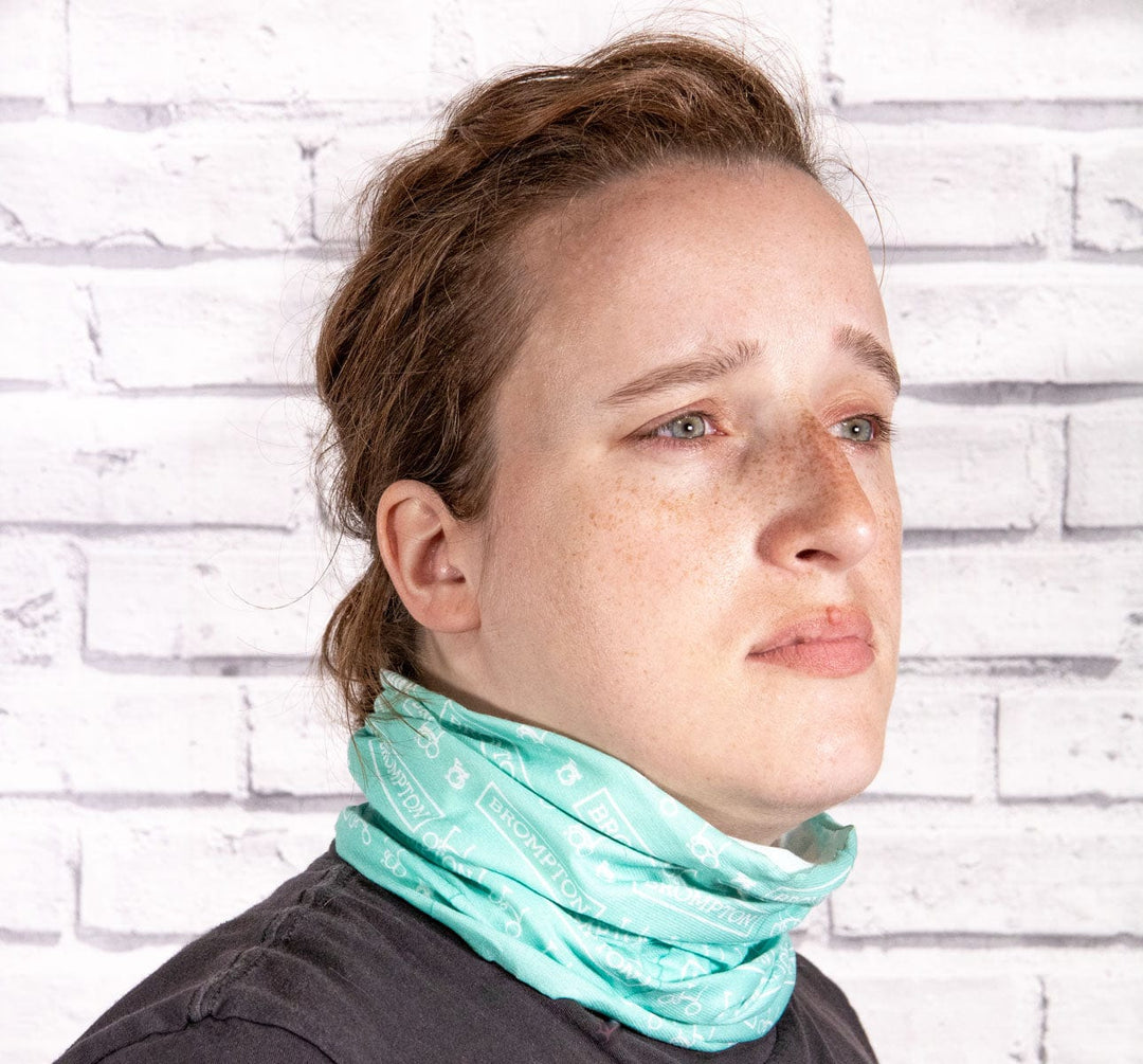 Brompton Buff in turkish green used as a neck scarf by woman.